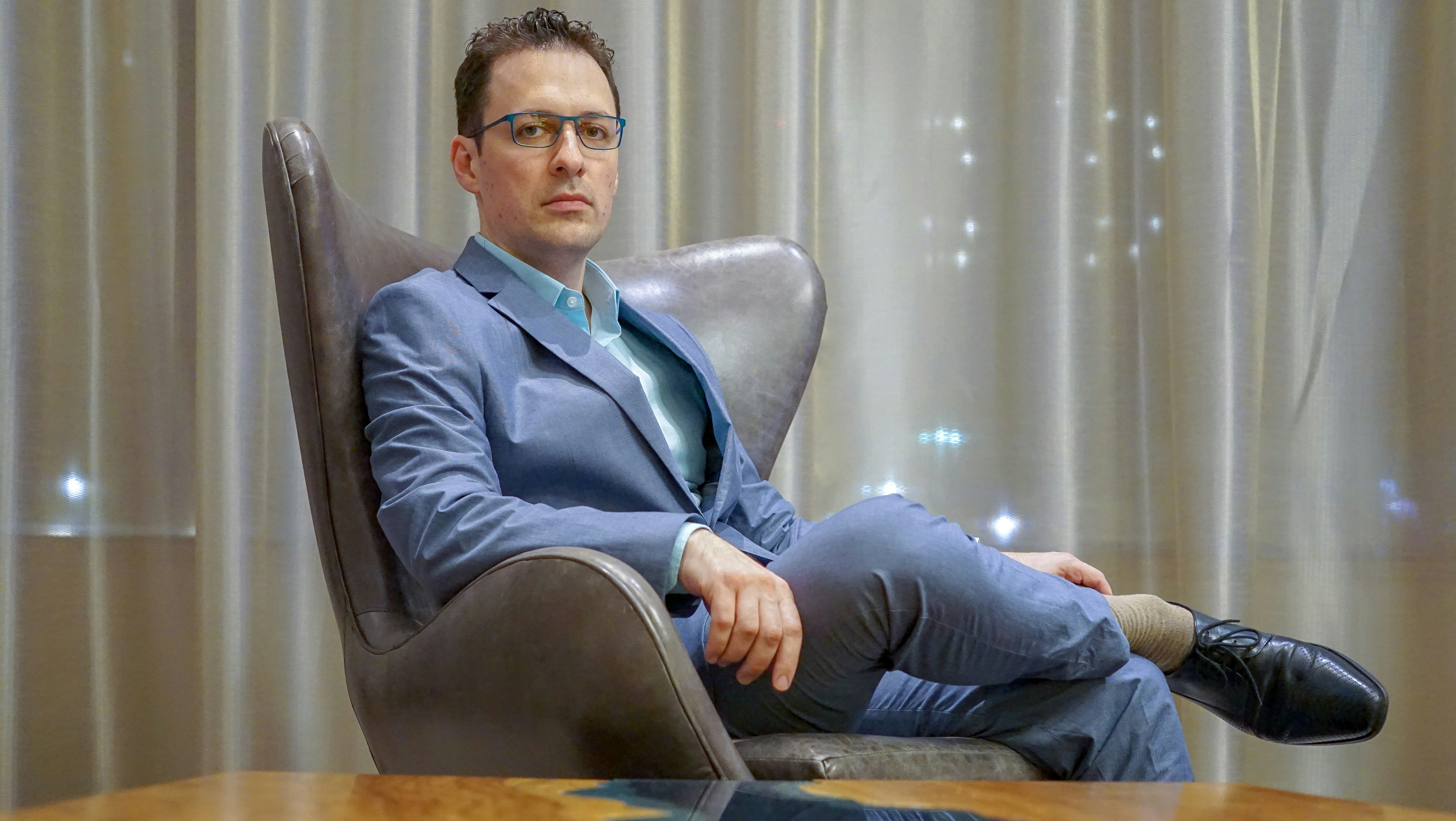 Man sitting in an executive chair with serious expression